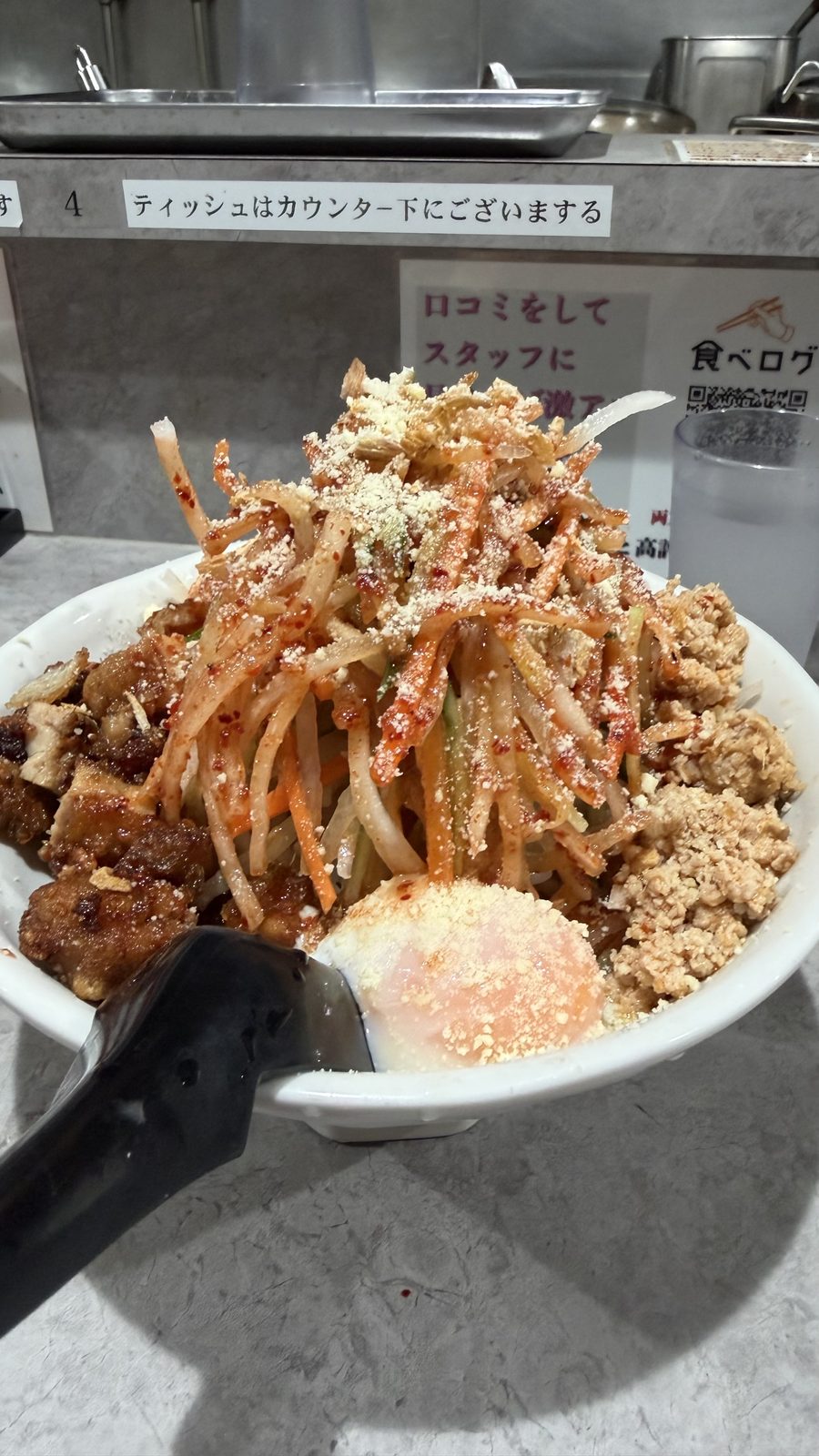 旨辛熟成味噌 麺屋アニキ（高田馬場）の具が山盛りのラーメンと店頭の看板