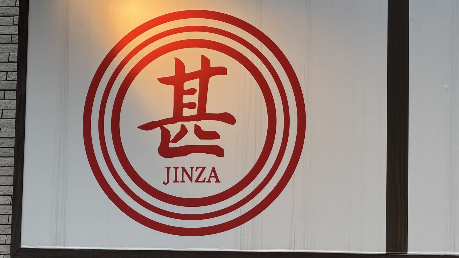 甚三 高田馬場店の店頭と、赤い「甚 JINZA」のロゴ看板